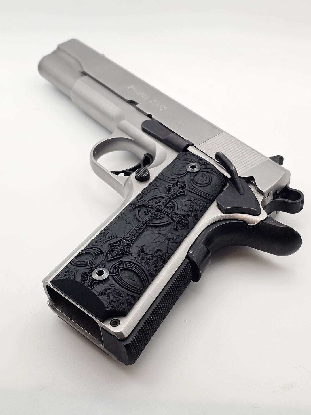 Close-up of Lambda Cross 1911 pistol grips mounted on the 1911